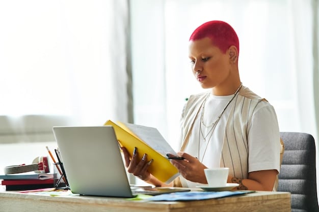 A student looking thoughtfully at a university brochure, with application forms and a laptop displaying a university website in the background. The setting is a quiet study area, emphasizing the importance of research and preparation in the application process.