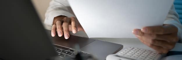 A close-up of hands completing an online unemployment benefit application form with a concerned expression, emphasizing the importance of accuracy and attention to detail.