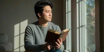 Person enjoying a book, taking a break from screen time for a digital detox